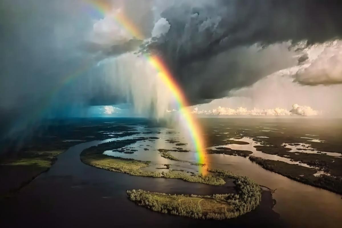 Amazon River aerial view after a thunderstorm, rainbow, cinematic
