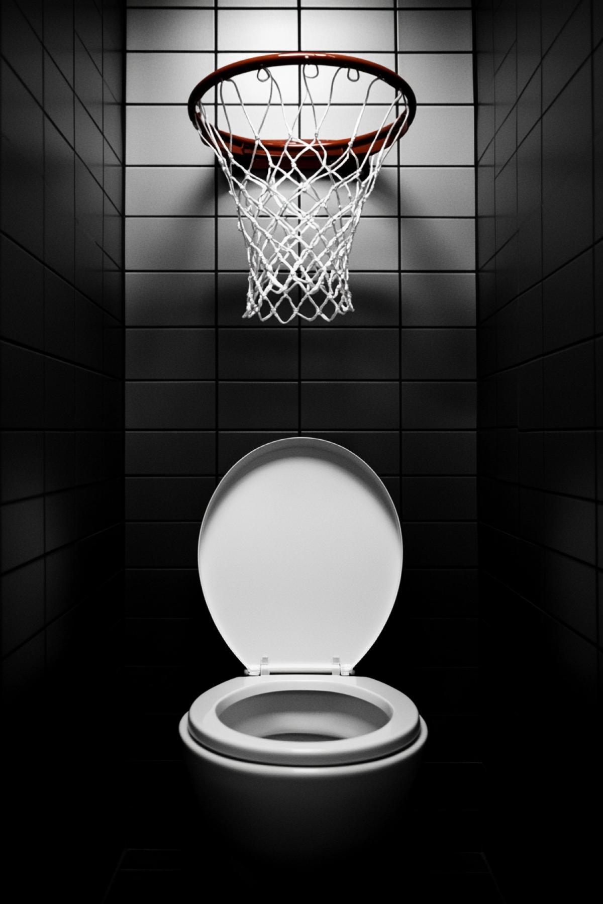 Basketball hoop over an open toilet.