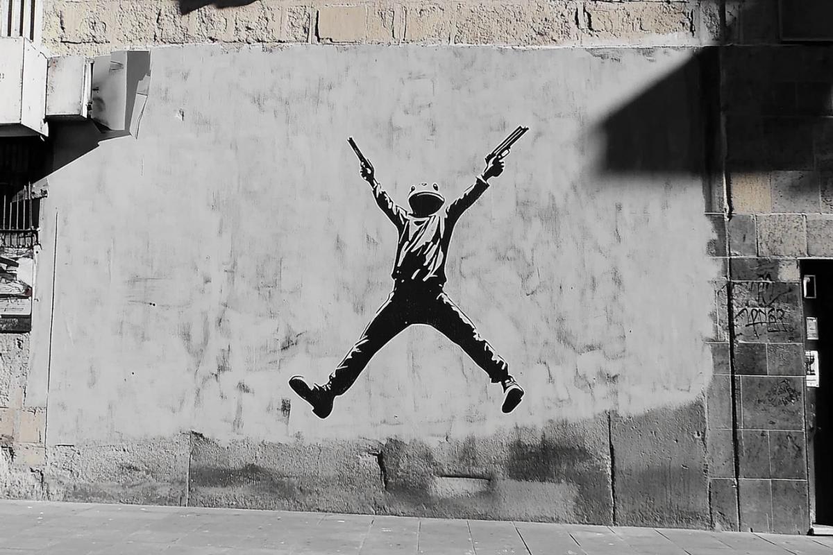 Frog with a machine gun, dark and white stencil drawing on the wall of an old house, Banksy style graffiti