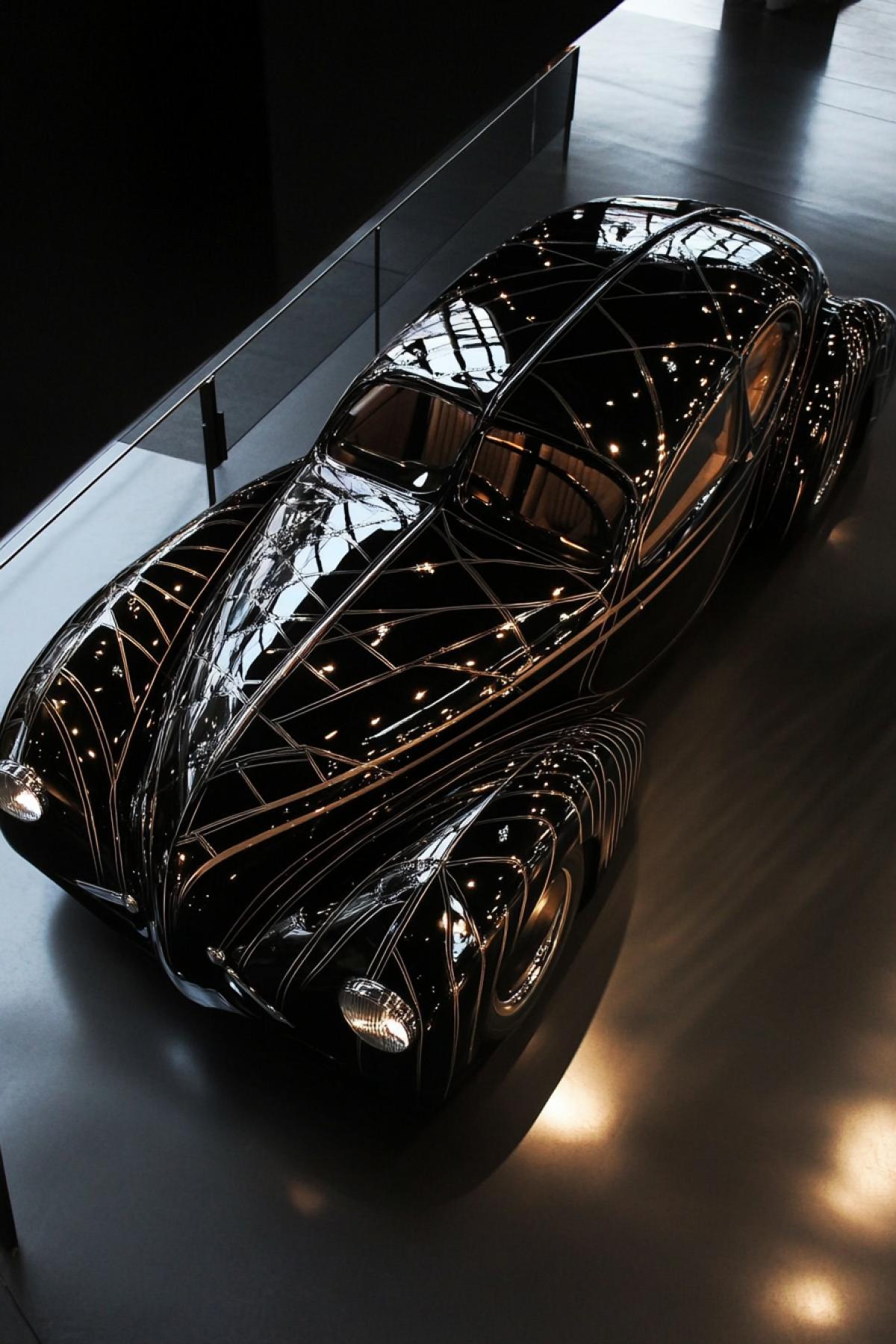Glossed dark auto decorated in style of Maurits Escher