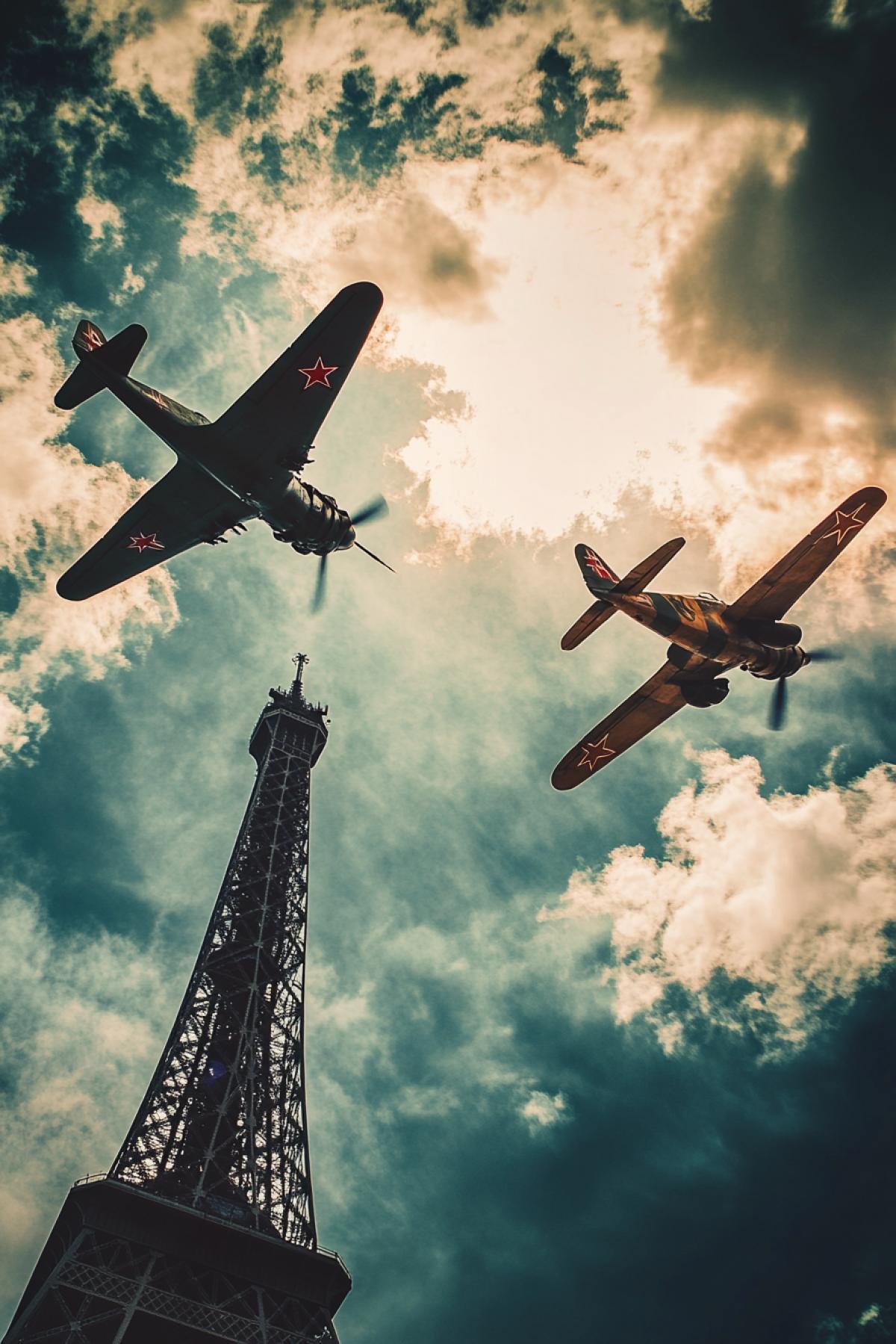 Two Aircrafts fight in skies over the Eiffel tower epic combat soviet vs german plane vibrant bright colours high contrast
