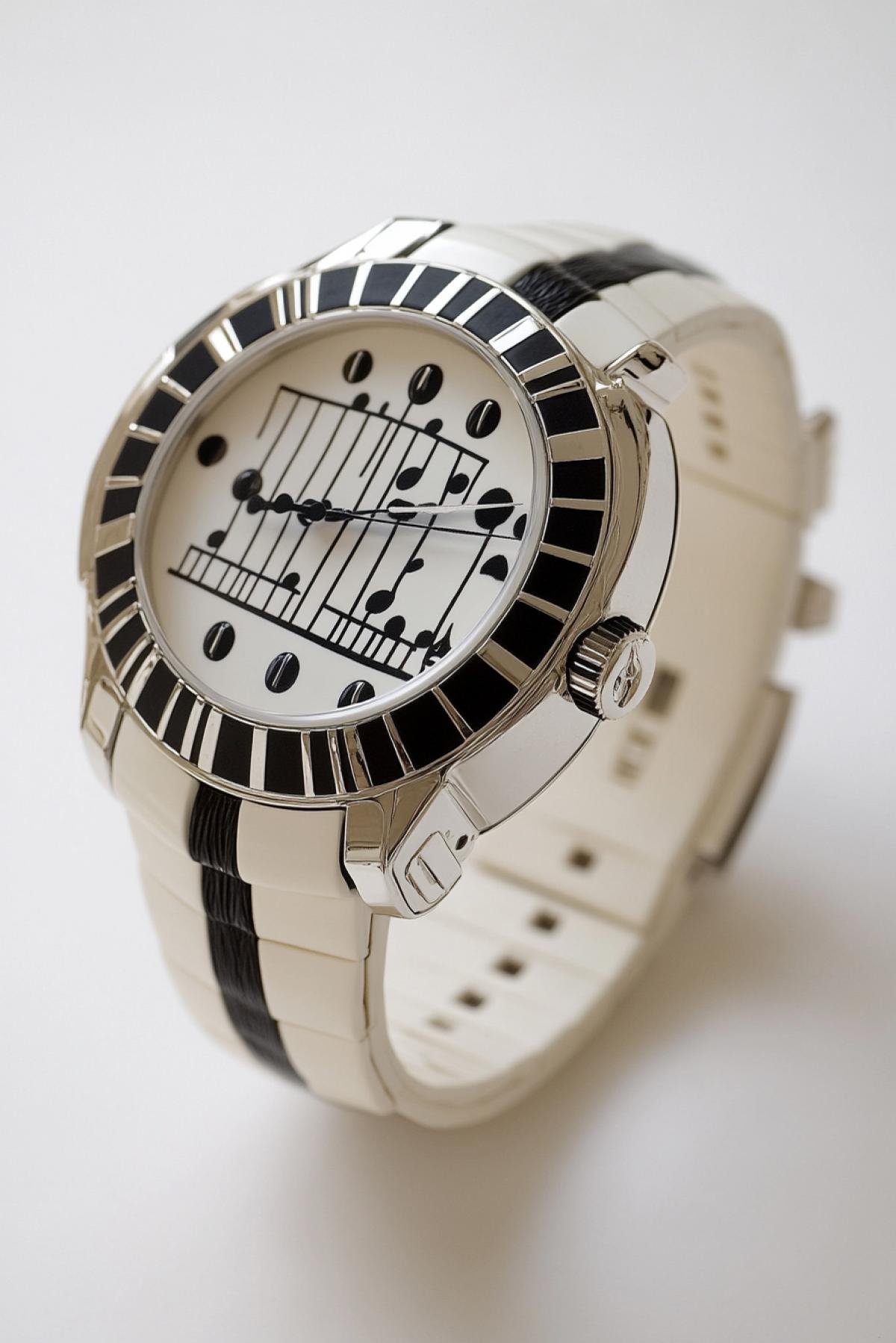 A wristwatch that transforms time into a symphony. The watch face displays a rotating staff of musical notes, with the hour and minute hands acting as conductors. Each passing hour triggers a unique melody, synchronized with the users mood or environment. The strap is designed from a material resembling piano keys, while the crown is shaped like a treble clef.