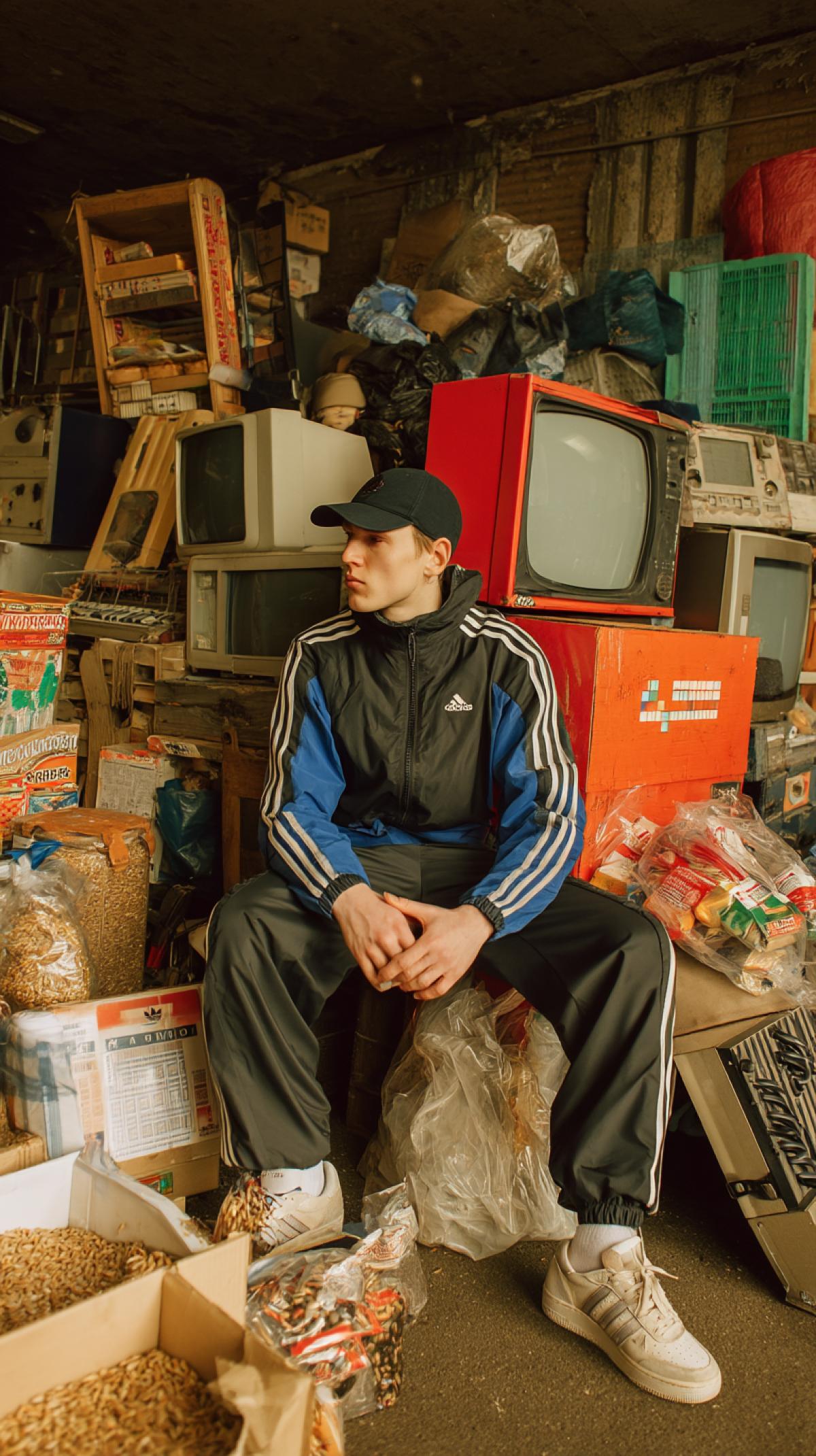 Attributes of the 90s Russia. Tetris, Adidas tracksuit, sunflower seeds in an envelope from a newspaper, garages, musical cash desks