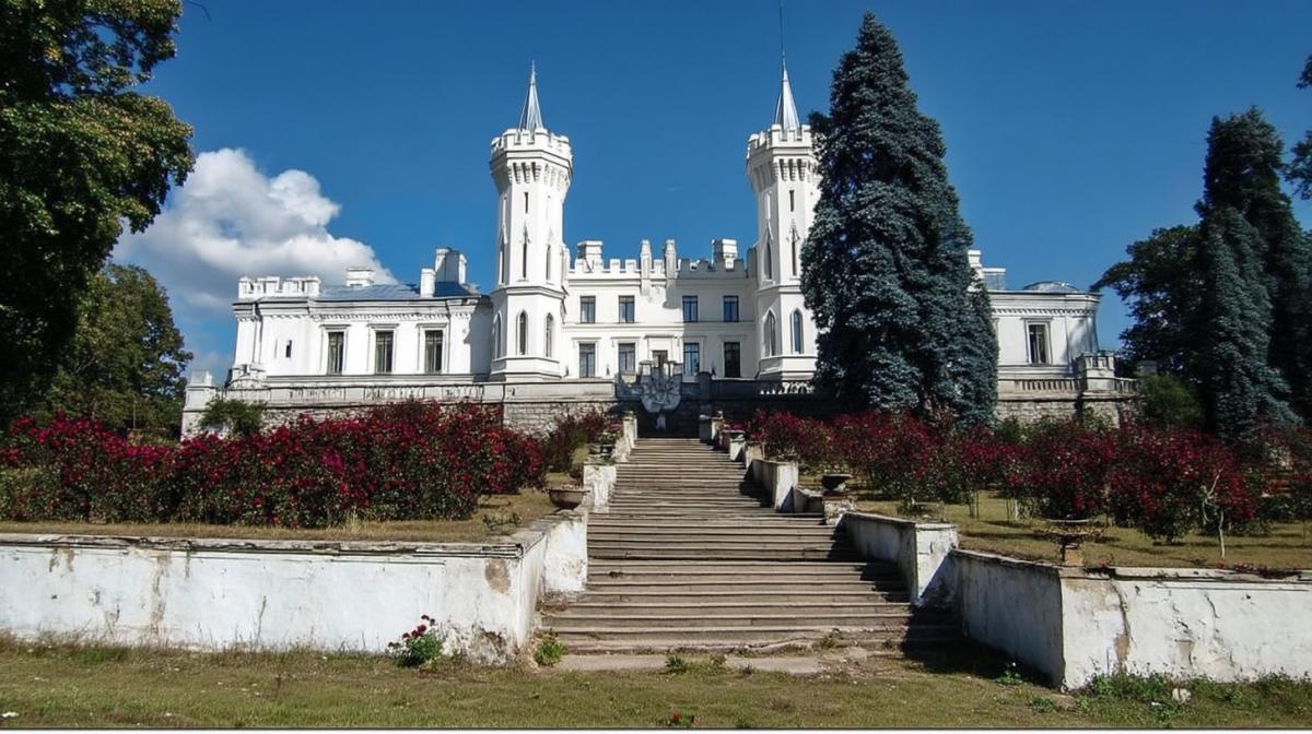 the white castle of the 18th century, with two towers and a cascading staircase, roses in flower beds, blue fir trees, sunny, professional photo