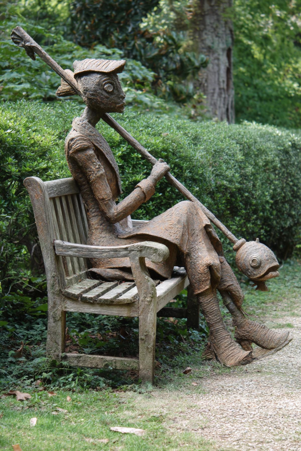 Fish Hammer in the form of a woman in a resting on a bench