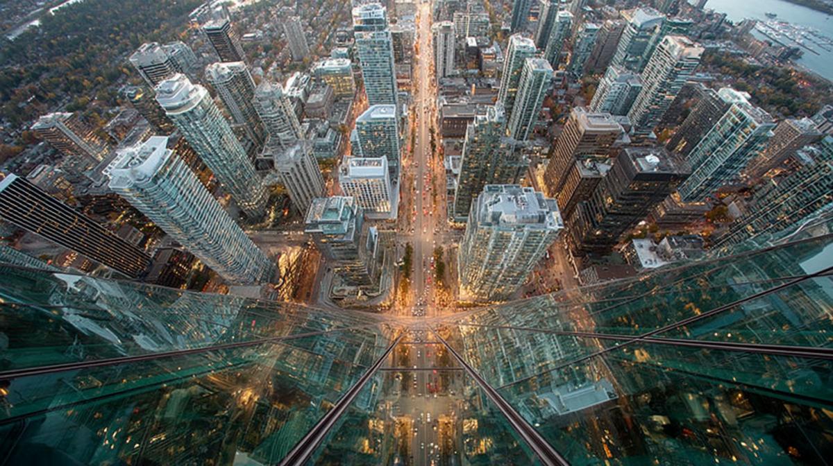 View from a skyscraper, frightening height below, small people glass buildings