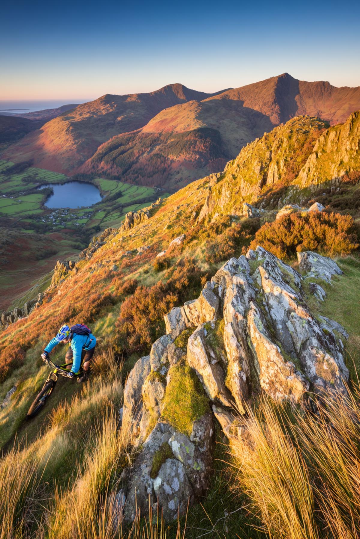 A cyclist in the mountains on a mountain bike, a beautiful photograph expressing freedom and movement