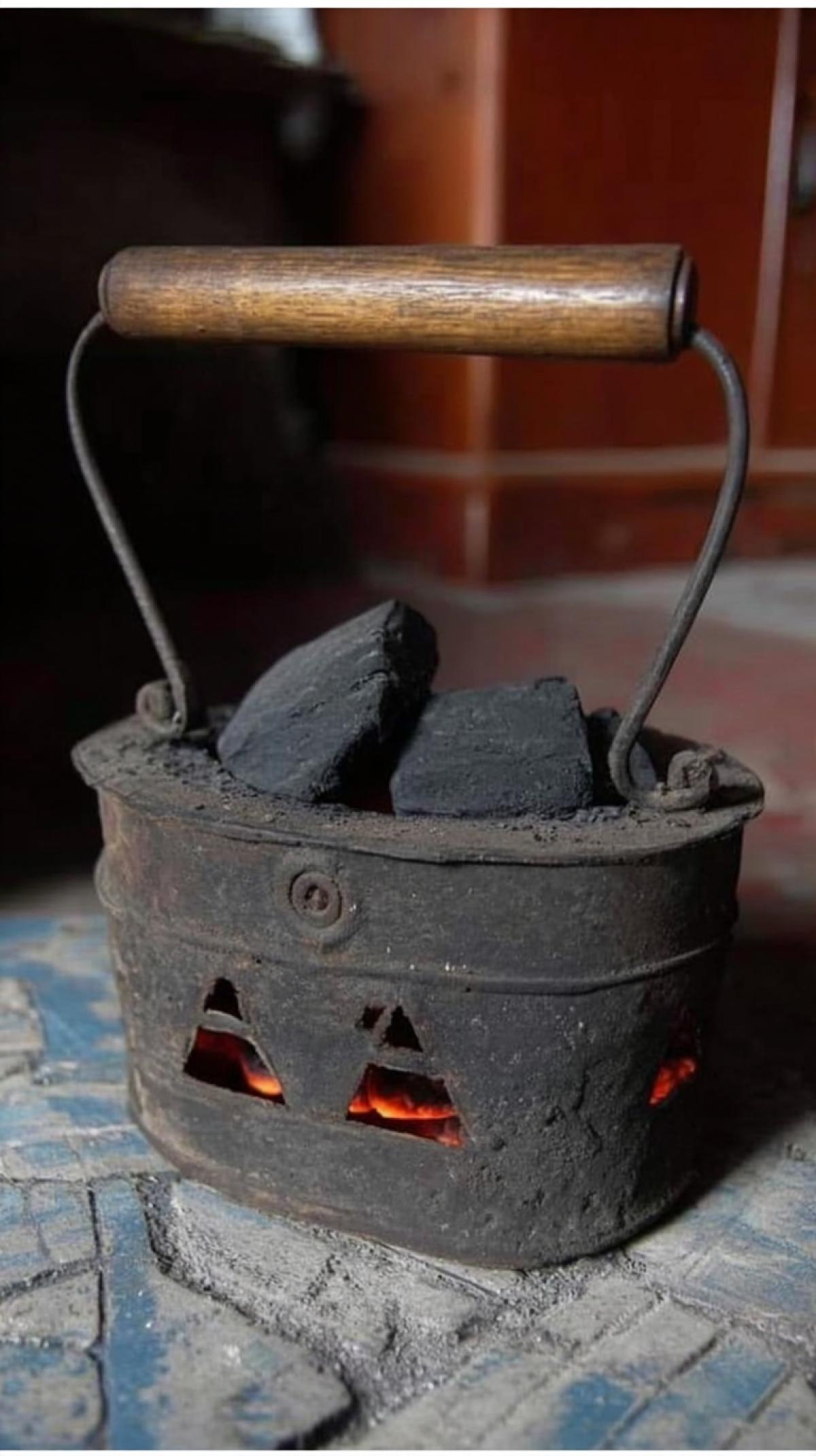 iron with burning coals inside, with a wooden handle, mid-18th century, photo, background: Russian stove