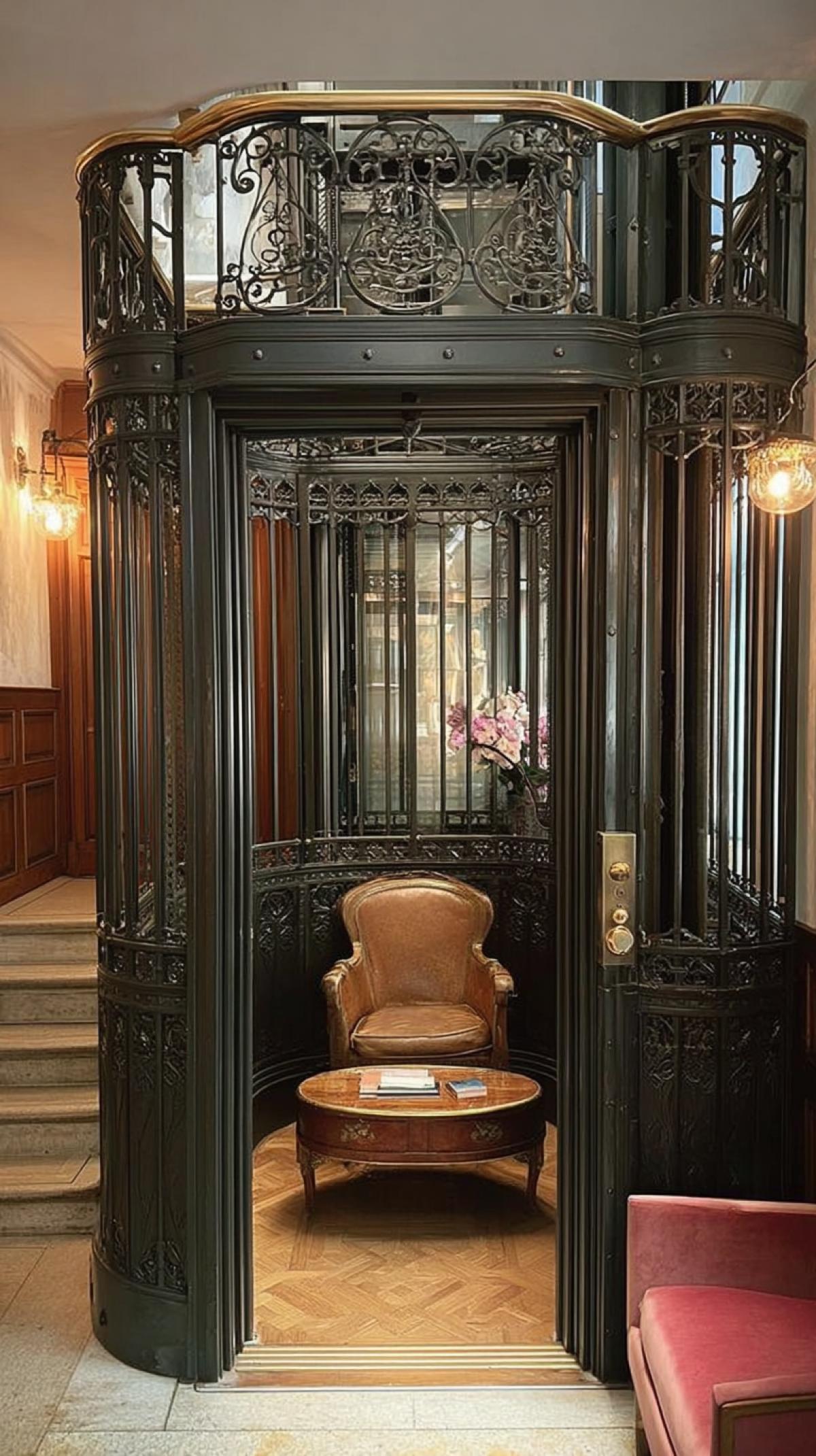 an 18th-century cast-iron elevator with a coffee table and an armchair inside