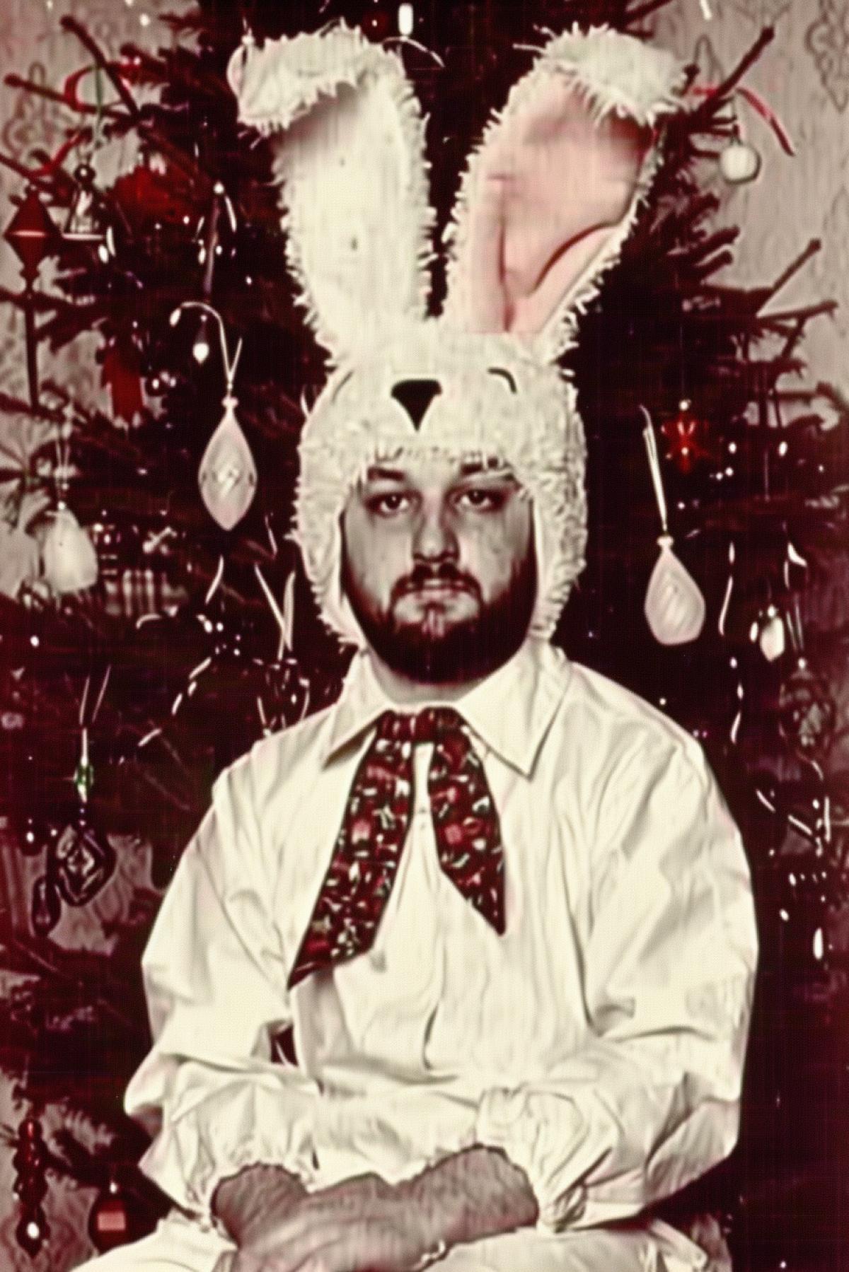 A 45-year-old bald man with a beard and beer belly, wearing a shabby bunny costume, sitting sadly under a Christmas tree. The tree is decorated with colorful lights and ornaments, contrasting with his melancholic expression. Photorealistic, cinematic lighting, 8k, detailed textures of the costume and tree, humorous yet touching atmosphere.