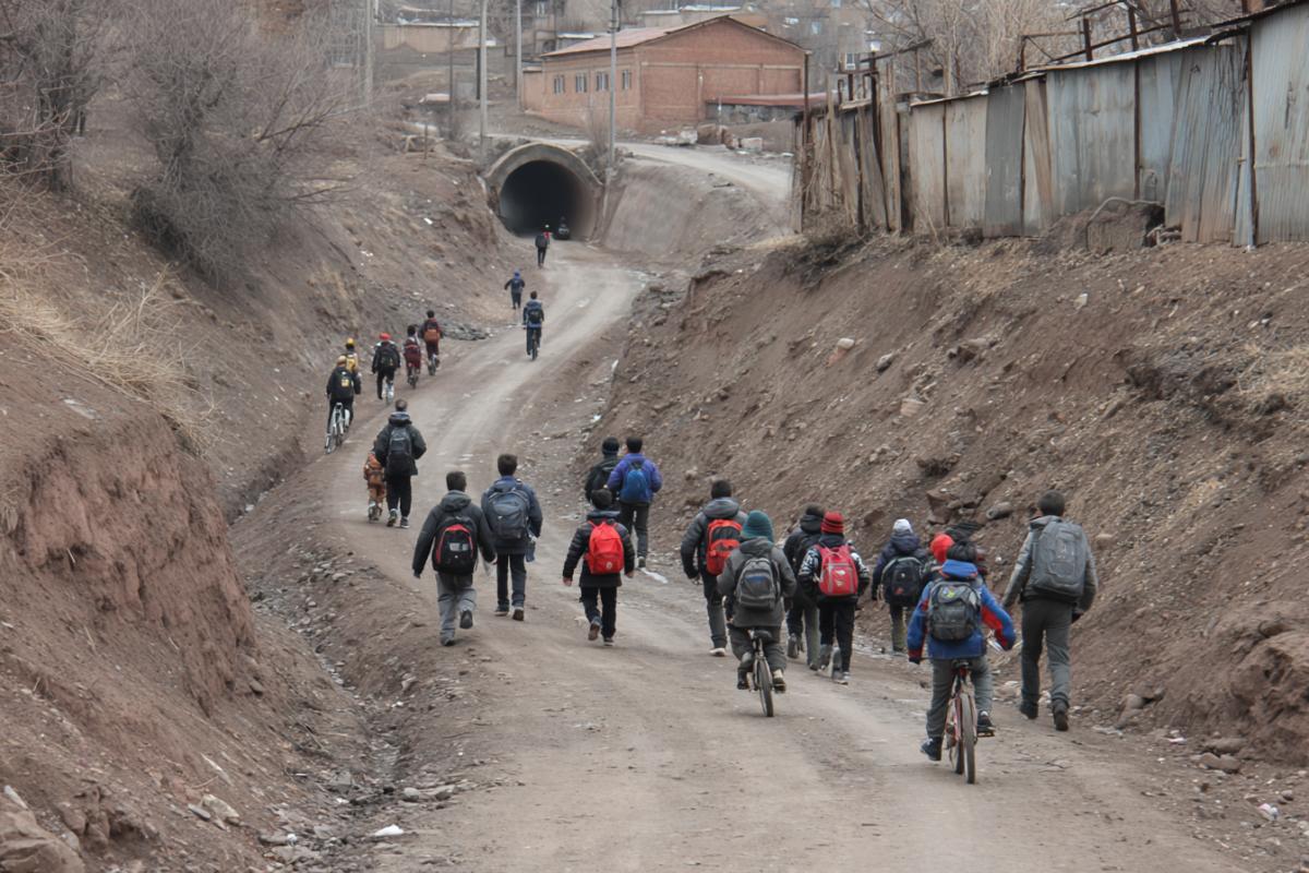 Dangerous with obstacles road to school, schoolchildren go along it