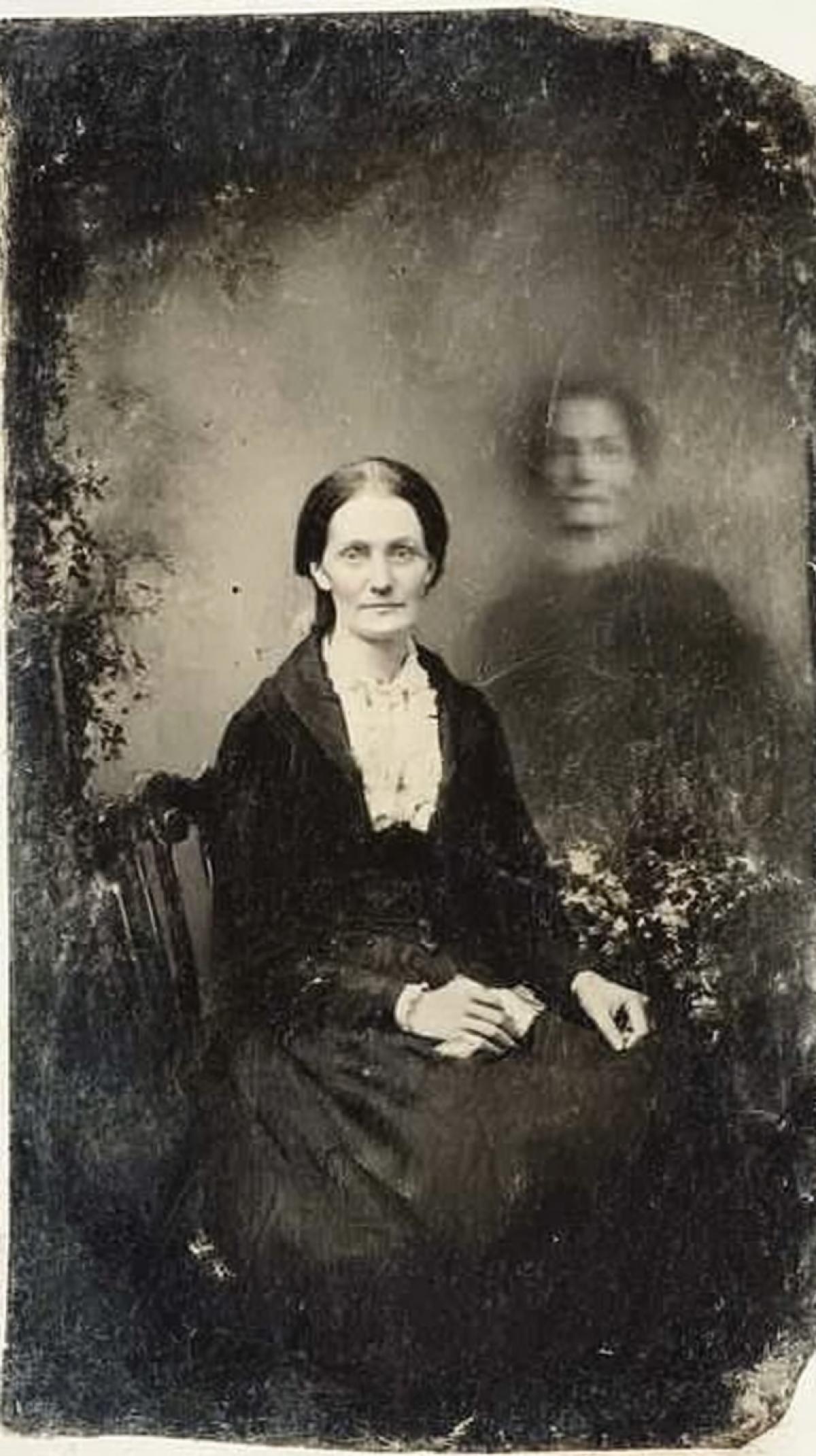 1870s, double exposure, tintype portrait of a woman with a ghost, photo of a ghost figure behind the woman