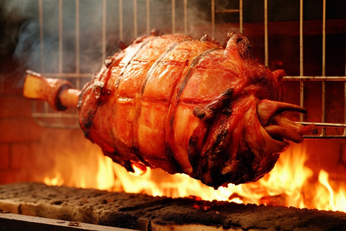 Roast bull on a spit over a fire close-up